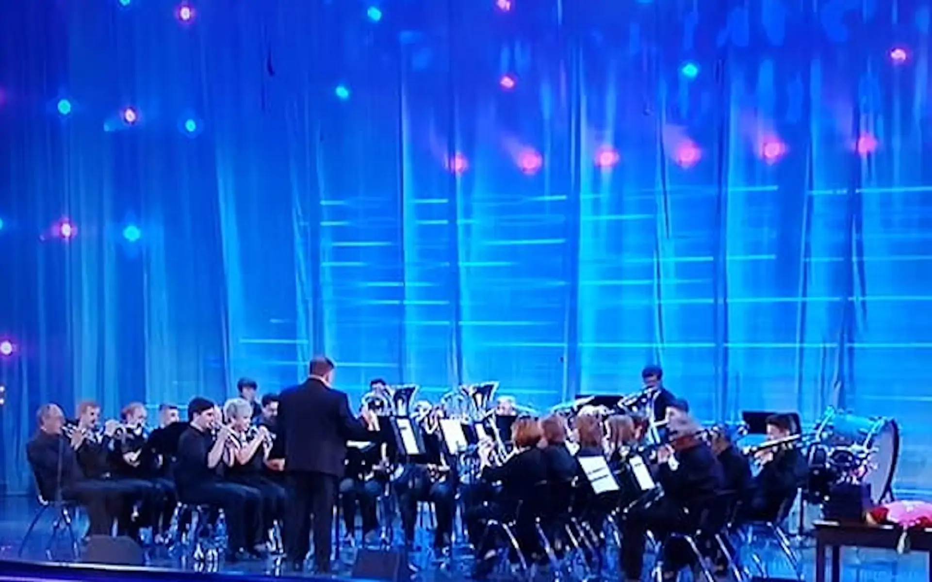 Briton Ferry Silver Band on a brightly lit blue stage at the National Eisteddfod contest.
