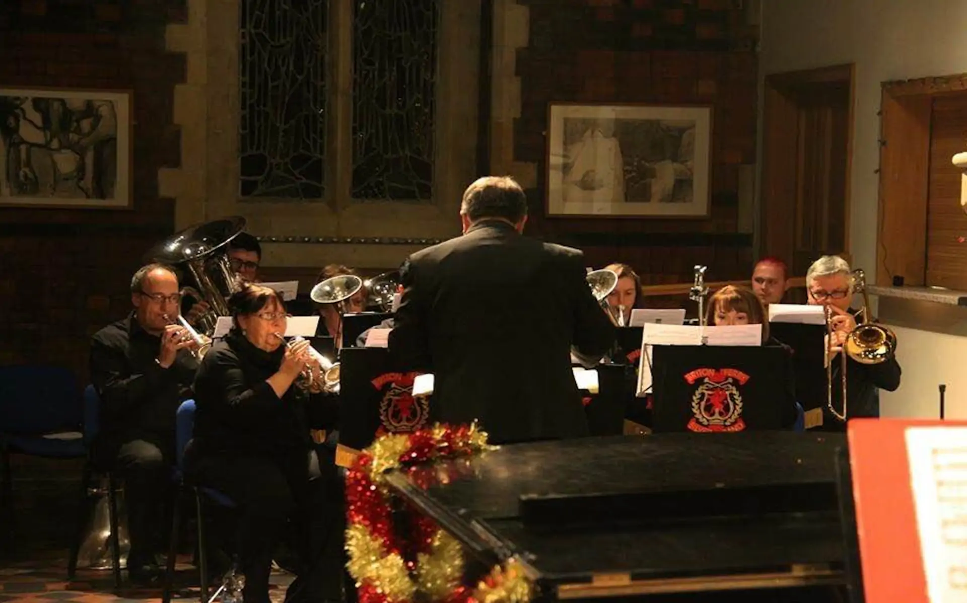 A small group of players from Briton Ferry Silver Band in concert in a church.